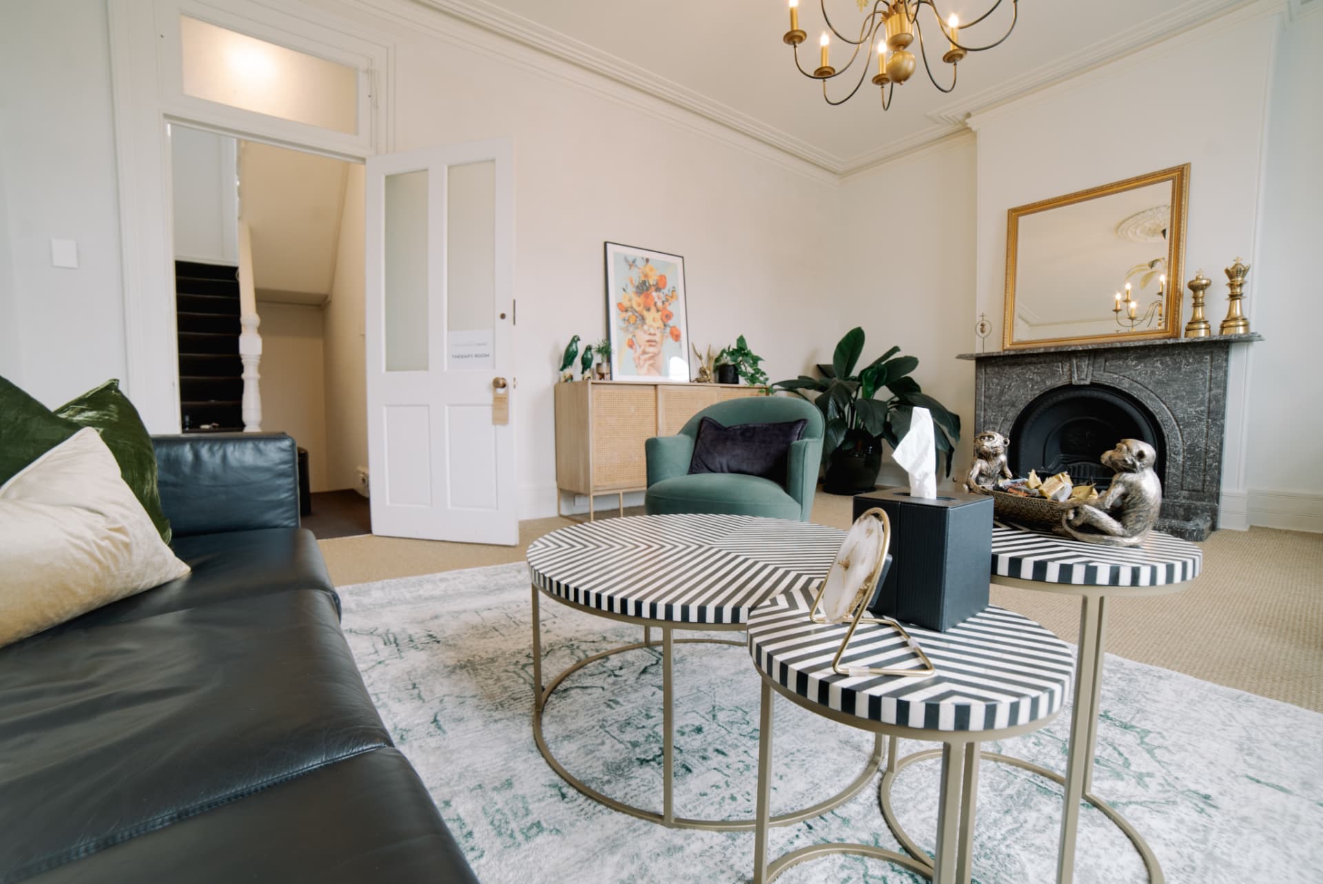 Quiet consulting room with armchairs, fireplace and soft natural light