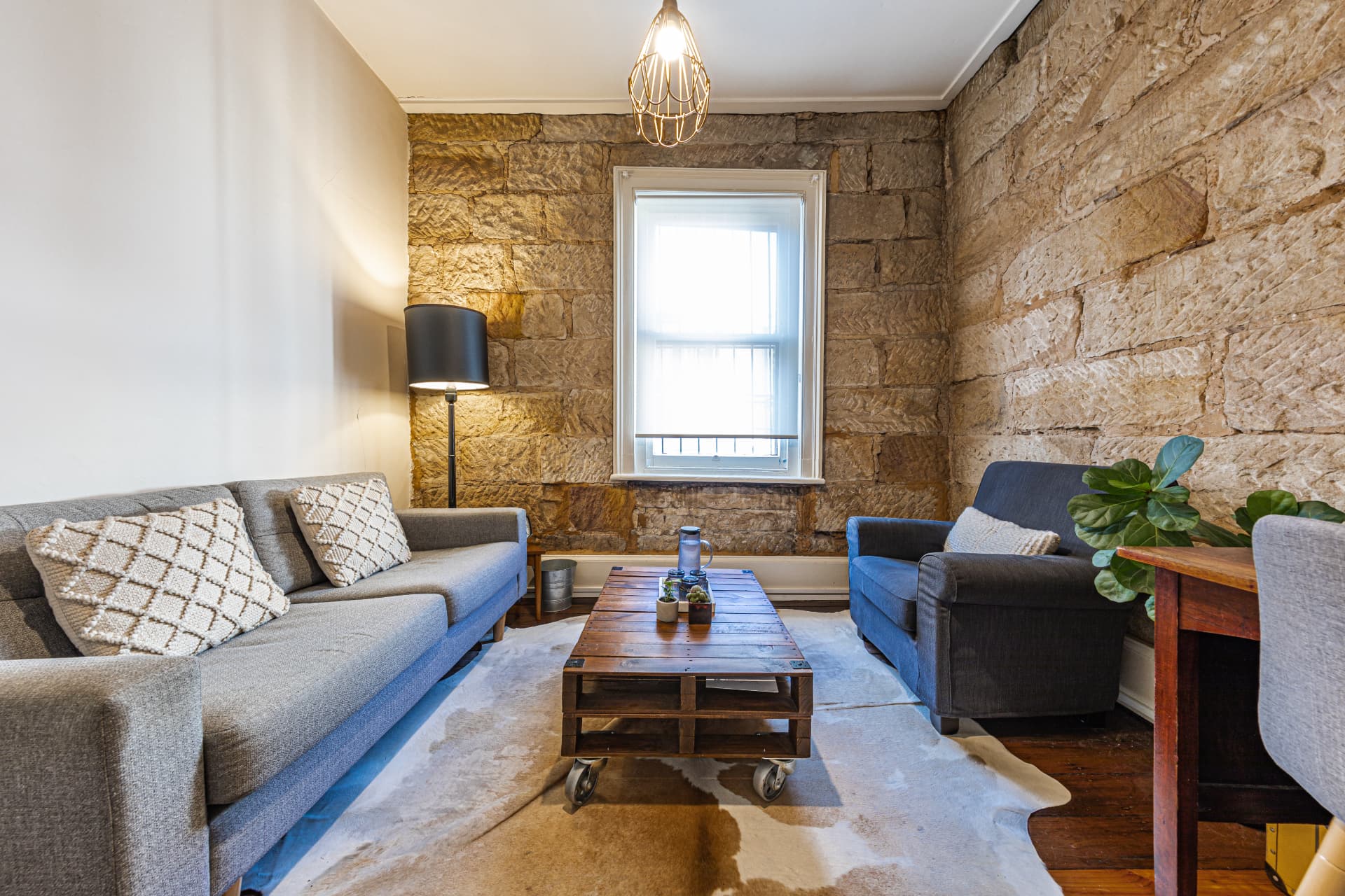 Warm therapy space with stone walls and comfortable seating for family sessions